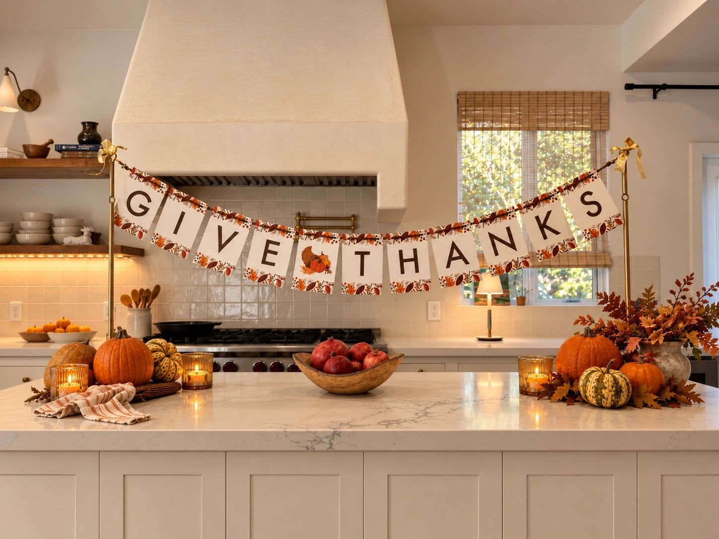 Give Thanks banner on the gold Celebration Stand across a kitchen island with pumpkins and candles